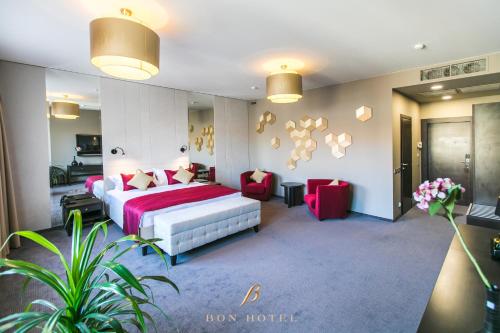 a hotel room with a bed and two chairs at Bon Hotel in Dnipro