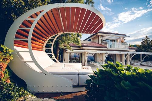 a white chair with an orange umbrella on a house at Villa STAMIRA in Ancona