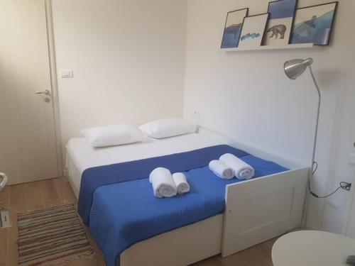 a small bedroom with a bed with towels on it at Apartments and Rooms Stone House in Split