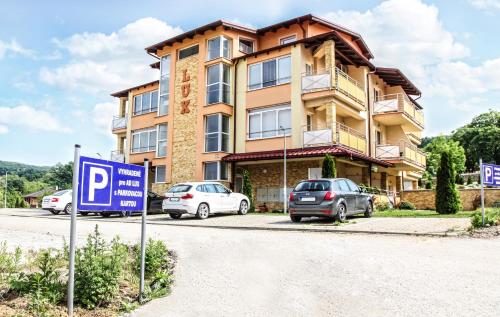 a house with cars parked in front of it at Apartmány RELAX Podhájska in Podhájska