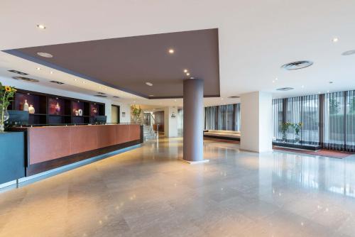 an empty lobby with a bar in a building at Eurostars Isla de La Toja in Isla de la Toja