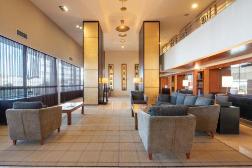 a lobby with couches and chairs in a building at Eurostars Isla de La Toja in Isla de la Toja