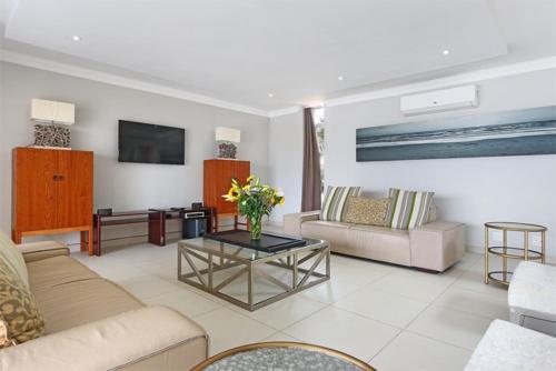 a living room with a couch and a table at Vetho House Villa Ballito in Ballito