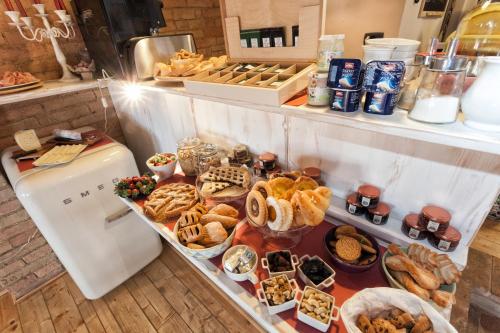 a buffet with different types of food on a table at Scalette di Piazza B&B in Montalcino