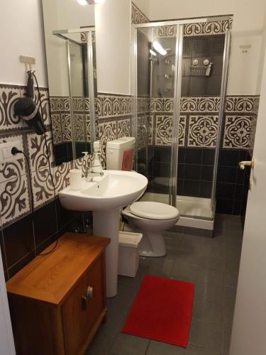 a bathroom with a sink and a toilet and a shower at B&B Villa Italia in Salerno