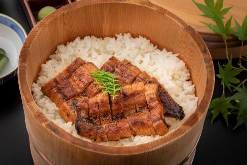 a bowl of rice with meat on top of it at Sansuikan Kinryu in Hamamatsu