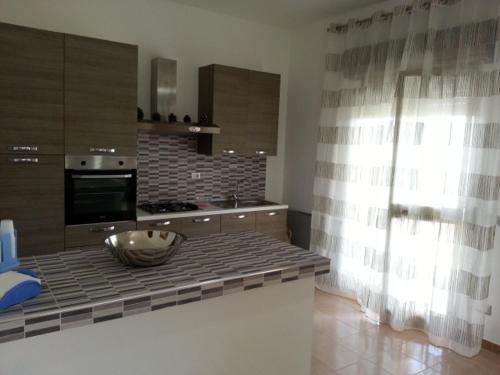 a kitchen with a counter with a bowl on it at Villa Fiorella in Sciacca