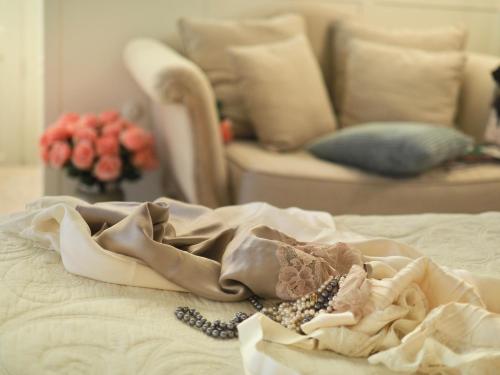 a blanket on a bed in a living room at LES ANGES DELUXE AVIGNON - Exclusive Romantic Home - Private Luxury Tours in Avignon