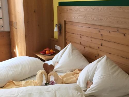 a bed with two stuffed swans sitting on it at Haus Schnepfleitner in Dorfgastein