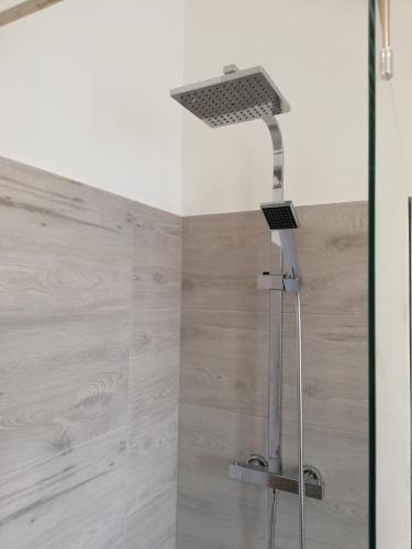a shower with a shower head in a bathroom at UP&B Rooms Catania in Mascalucia