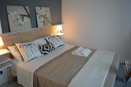 a bedroom with a large bed with two pillows at UP&B Rooms Catania in Mascalucia