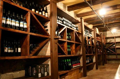 a wine cellar with lots of bottles of wine at Villa Maria in Belvedere di Spinello