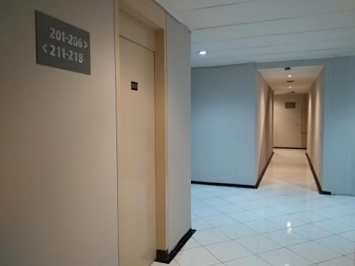 a hallway in a building with a sign on the wall at K-Style Eco Hotel Jakarta in Jakarta
