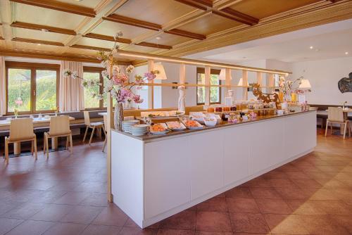 a kitchen with a counter and a dining room at Pension Christl in Caldaro