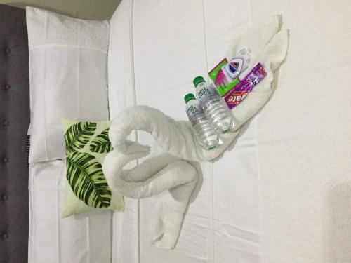 a towel animal shaped like a swan with a bottle of water at Palm Tree Villas 2 in Manila