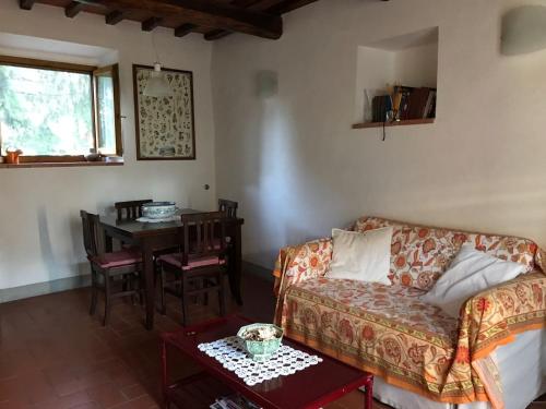 a living room with a couch and a table at Montebeni Apartments in Greve in Chianti