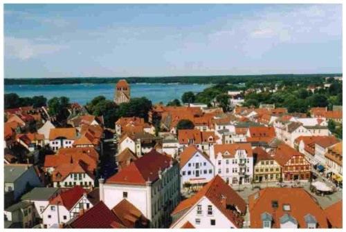a town with red roofs and a large city at Appartment Haus Sandra in Waren