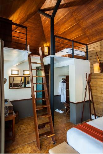 a room with two bunk beds and a ladder at Rodavento Boutique Hotel & Spa in Valle de Bravo