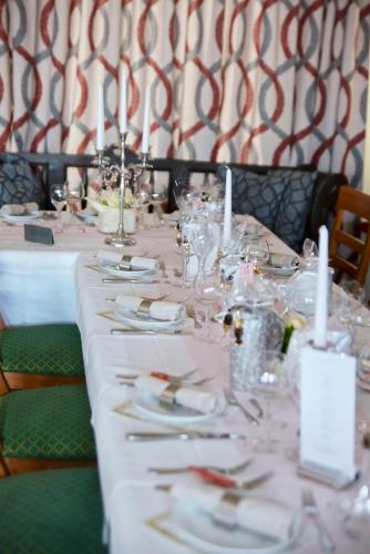 a long table with plates and silverware on it at La Stella in Süßen