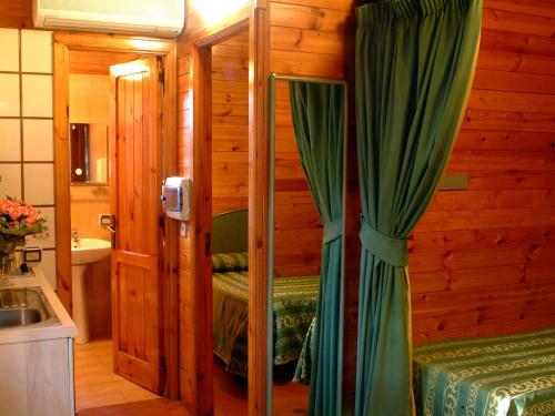Residence Villaggio Verde في سورينتو: حمام مع سرير ودش في غرفة