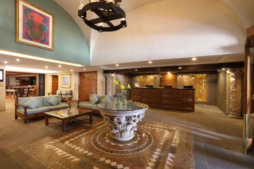 a living room with a couch and a table at Emporio Zacatecas in Zacatecas