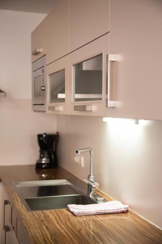 a kitchen with a sink and a counter top at Apartments Reiterbäck in Wagrain
