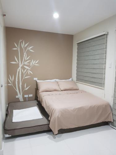 a bedroom with a bed and a large window at Skymagz 314 at Cityscape Residences in Bacolod