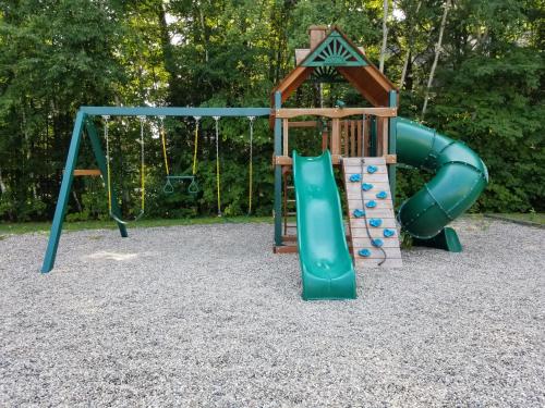 a playground with a slide and a swing at Eastern Inn & Suites (formerly Eastern Inns) in North Conway