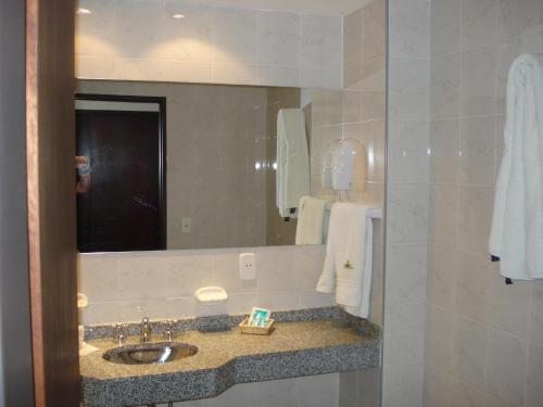 a bathroom with a sink and a mirror at Villa de Merlo All Inclusive & Spa by MH in Merlo