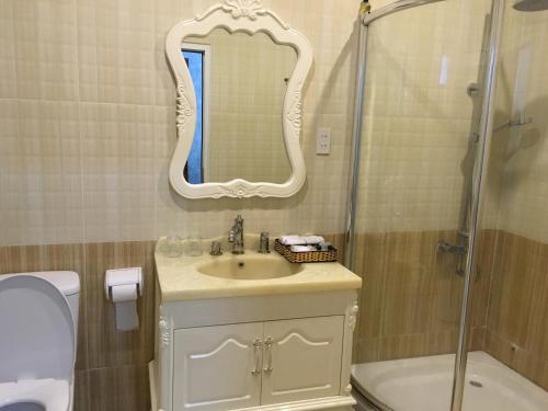 a bathroom with a sink and a shower and a mirror at Nancy Bridge View A1206 in Ho Chi Minh City