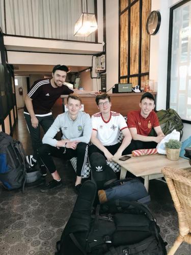 a group of young men sitting around a table at Arun Old Town in Bangkok