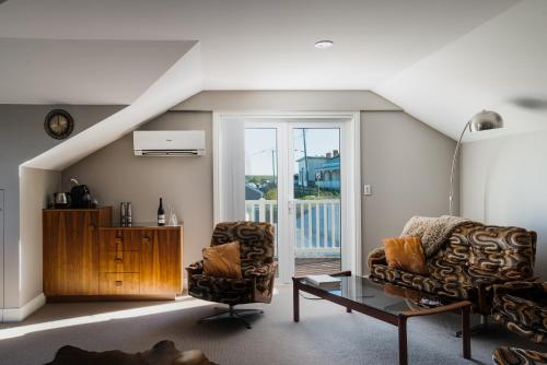 a living room with two chairs and a table at The Ark Stanley Luxury Bed and Breakfast in Stanley