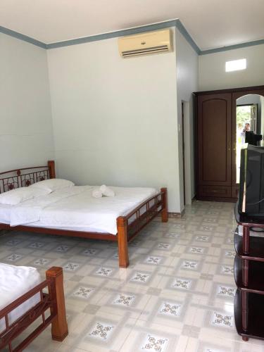 Ένα ή περισσότερα κρεβάτια σε δωμάτιο στο Bí Homestay