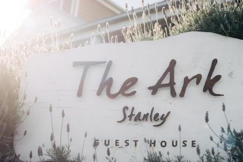 a sign for the art shingle guest house at The Ark Stanley Luxury Bed and Breakfast in Stanley