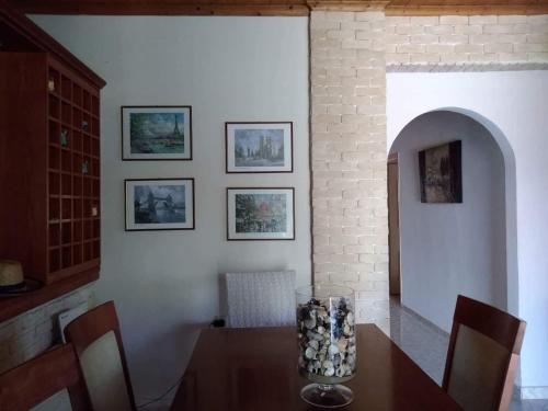 a dining room with a table with a vase on it at Villa Thanos in Marathias