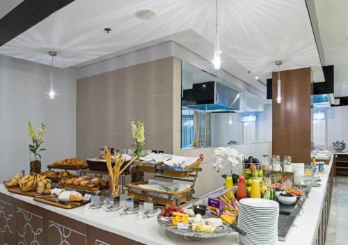 a kitchen with a buffet of food on a counter at The Envoy Hotel Abuja in Abuja