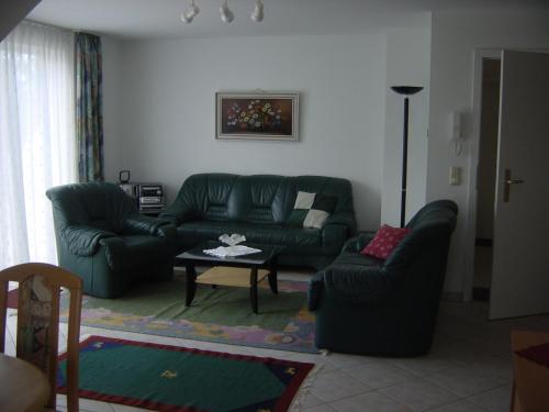 a living room with a couch and a table at Haus Galerie 1. OG in Ostseebad Karlshagen