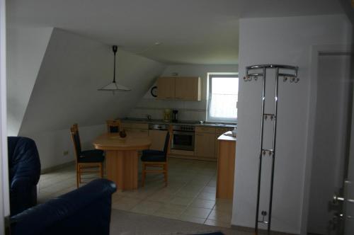 a small kitchen with a small table and a kitchen with at Haus Galerie 1. OG in Ostseebad Karlshagen