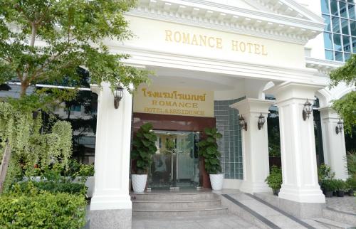 a hotel front of a building with pillars and plants at Romance Hotel Sukhumvit 97 in Bangkok