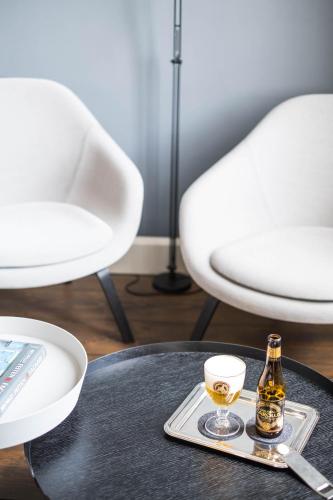 a bottle of beer and a glass on a table at B&B Dusk till dawn in Mechelen