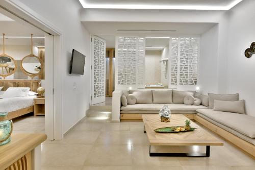 a living room with a couch and a table at Anax Resort and Spa in Agios Ioannis Mykonos