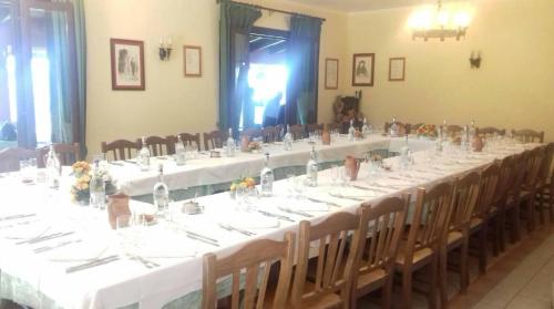 a long table with white tables and chairs at Azienda Agrituristica Salella in Salento