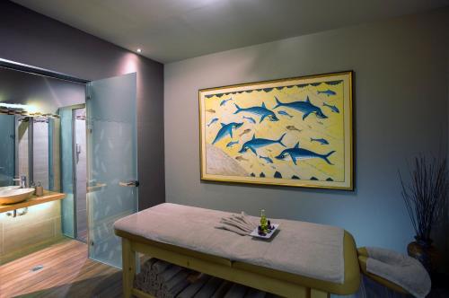 uma casa de banho com uma pintura de golfinhos na parede em Atlantis Beach Hotel em Rethymno Town