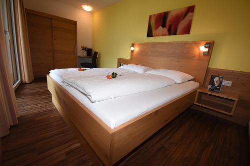 a bedroom with a large bed with white sheets at Chalet Barbara in Ischgl