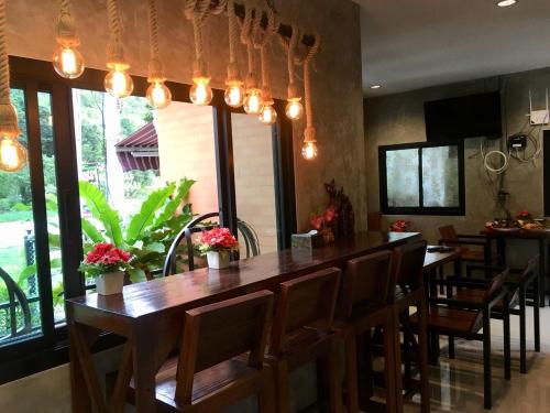 un restaurante con un bar con sillas y luces en River Hill Side Resort, en Ban Tha Thong Mon
