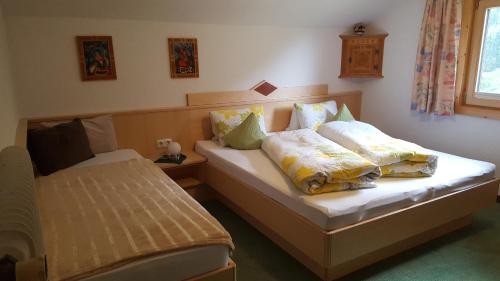 a bedroom with two beds with pillows on them at Haus Fernblick in Kappl