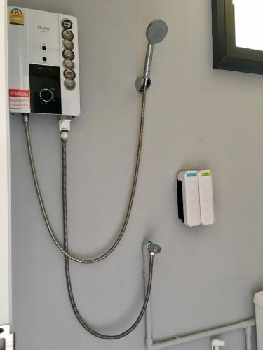 a stethoscope hanging on a wall in a bathroom at River Hill Side Resort in Ban Tha Thong Mon