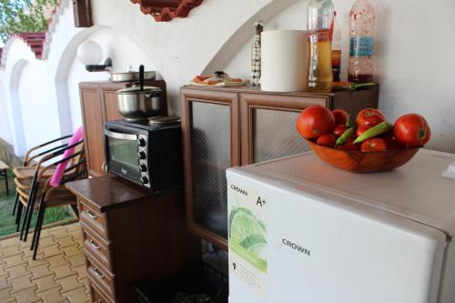 a kitchen with a bowl of fruit on top of a refrigerator at Siana House in Ravda