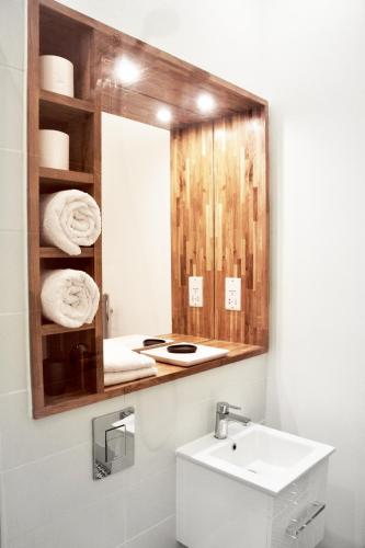 a bathroom with a sink and a mirror at Stylish Flat in 1860's Listed Building in Edinburgh