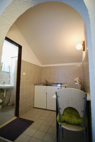 a kitchen with a table and a chair in a room at Apartment for 2 P. in Trogir